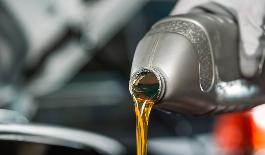 partial-view-of-mechanic-pouring-motor-oil-from-bo-2021-08-30-01-48-04-utc-jpg